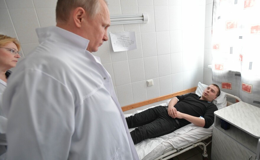 Putin visits a hospital to check on people injured in a fire that engulfed the Zimnyaya Vishnya shopping center in Kemerovo.