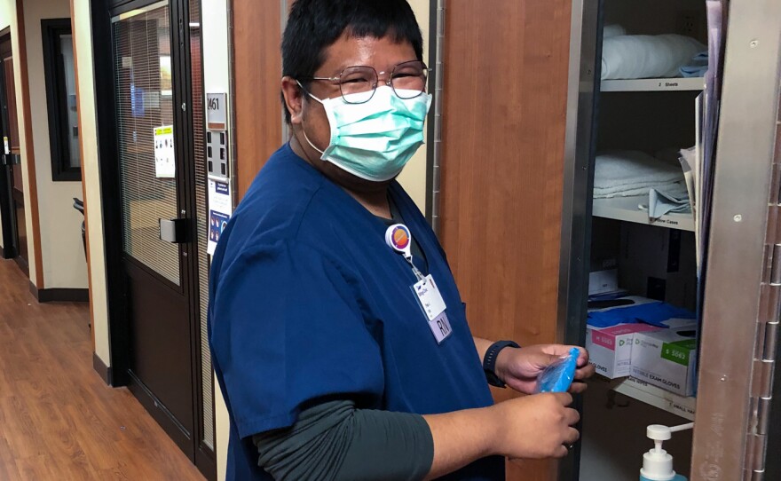 Pae Junthanam, a nurse from Thailand, grabs supplies from a closet in the intensive care unit at Billings Clinic.