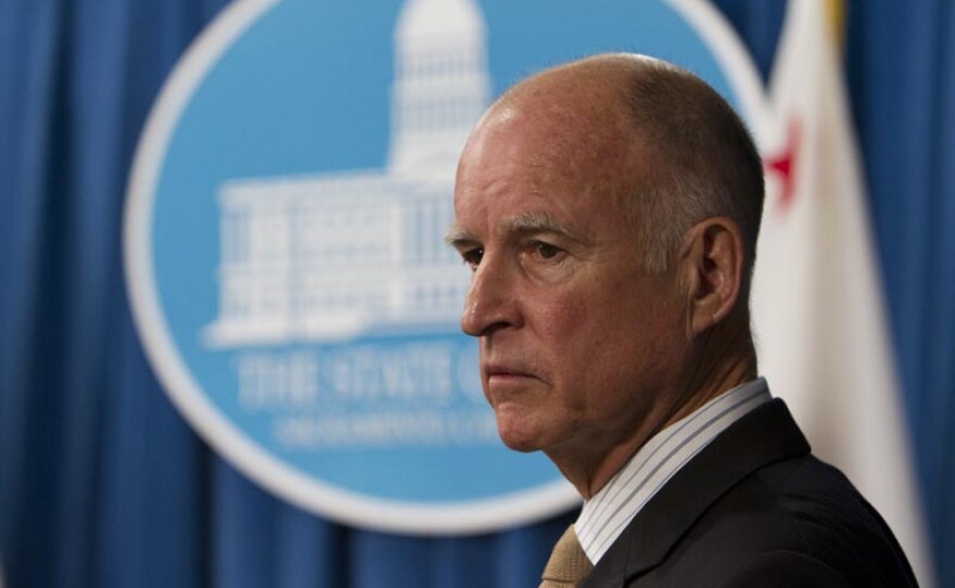 Gov. Jerry Brown discusses mid-year trigger cuts to the state budget at a Capitol news conference.