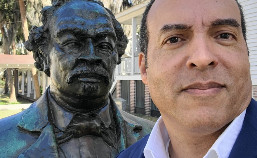 Michael Moore takes a selfie with a statue of his great-great-grandfather, the Union Navy hero Robert Smalls.