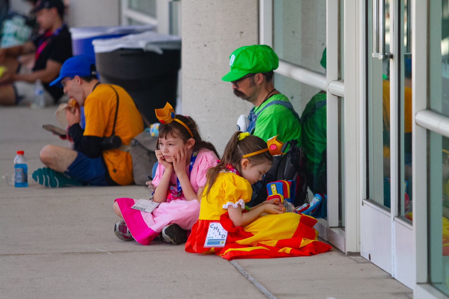 A mario costumed family take a break at Comic-Con, April 23, 2026.