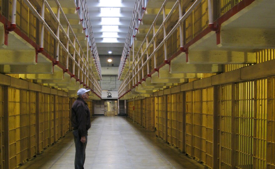 Bill Baker stares up at the rows of empty cells during his visit to the prison.