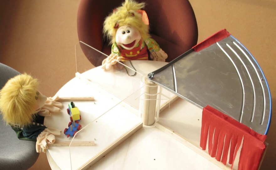 In some of the experiments, a puppet would "steal" a cookie from another puppet or the child by moving the turntable to place the treat in front of herself.
