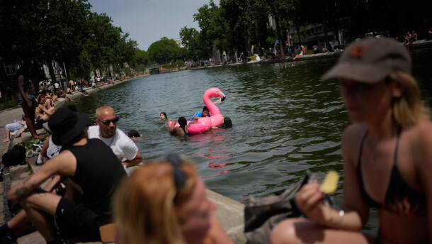 Parisians bath in the Canal Saint-Martin in Paris, as the national weather service, Meteo France, placed 54 departments, about half the country, under a red heat wave alert, Tuesday, June 23, 2026.