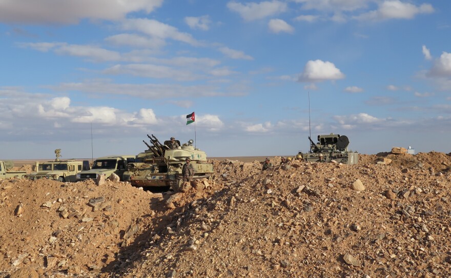 Jordanian tanks are stationed near a U.N.-funded clinic close to the border with Syria.