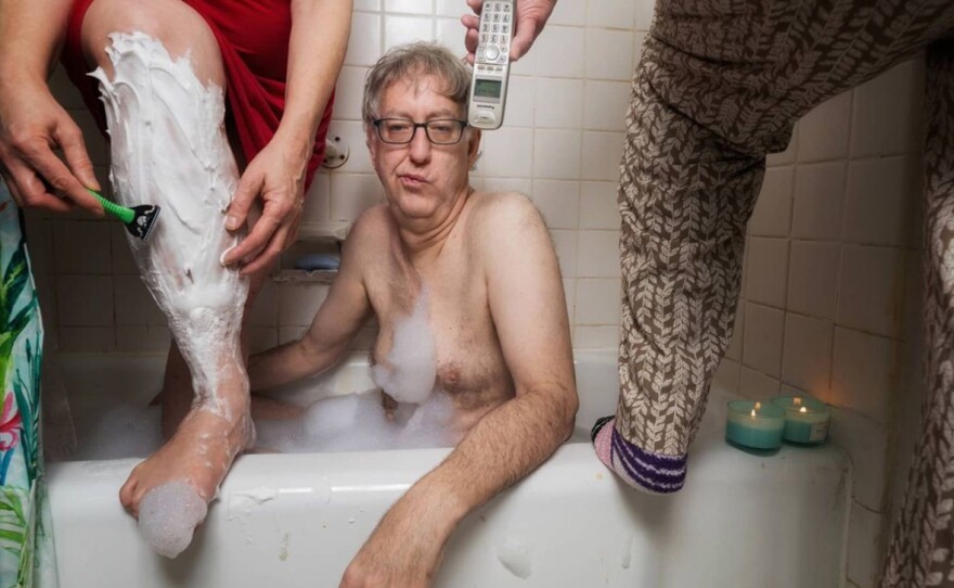 Sophia Lansky, Neil Kramer and Kramer's mother Elaine, crowd into their bathroom in Queens in April 2020 in a staged scene as part of photography project by Kramer.