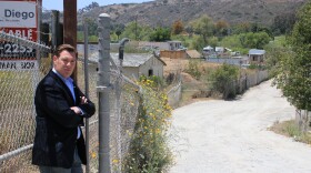 Anthony Wagner stands at the site of a future development along the San Diego River that's raised traffic and environmental concerns. 