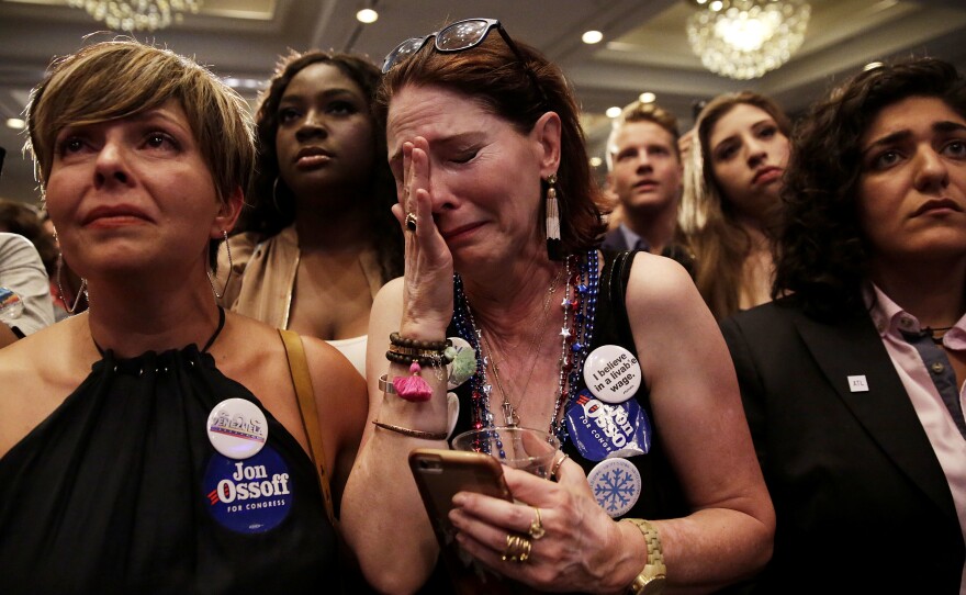 Jon Ossoff supporter Jan Yanes, center, cries as the Democratic candidate for the 6th congressional district special election in Georgia concedes Tuesday night.