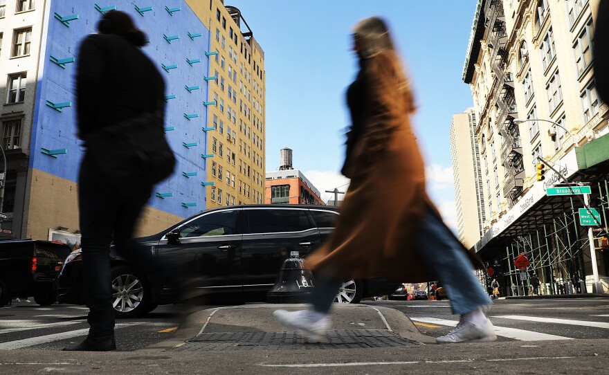 Pedestrians walk along a Manhattan street in New York City in March. A new report finds that SUVs are increasingly involved in fatal crashes with pedestrians.