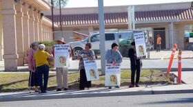 Volunteers carry signs that say "pray to end abortion" on the first day of a “40 Days for Life” event as builders work on the construction of the Planned Parenthood site on Fourth Street in El Centro, February 18, 2015.