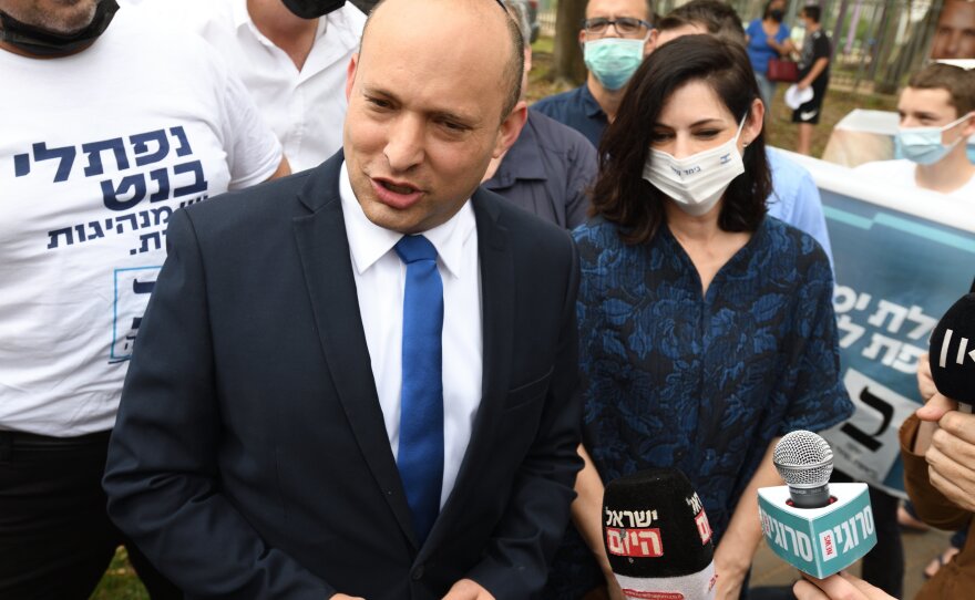 Bennett, head of the national-religious Yamina party, and his wife Gilat Bennett arrive at a polling station to cast their ballots in Ra'anana, Israel, in March.