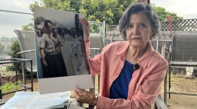 Chula Vista resident Sonia Lopez holds up photos from the Chicano Moratorium in Los Angeles, which she attended, Aug. 28, 2025.
