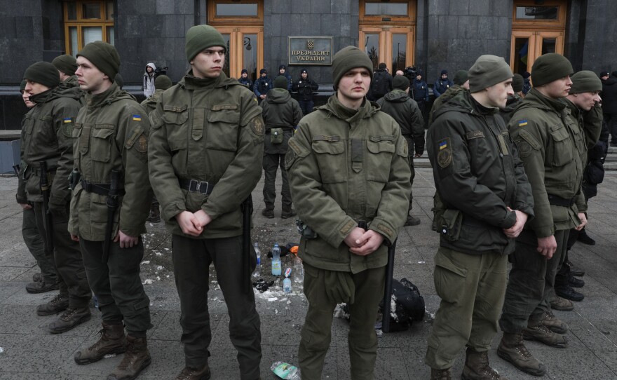 National Guards surround the place where a person immolated himself earlier in Kyiv, Ukraine, on Feb. 26, 2020. A man doused himself with a flammable liquid and set himself on fire in front of Presidential Office.
