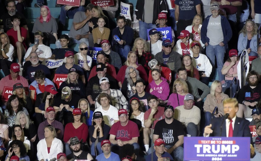 Supporters look on as Republican presidential candidate former President Donald Trump speaks to supporters during a rally Feb. 10 in Conway, S.C. As Trump has tried to remake the GOP in his image, local parties have resorted to infighting.