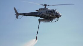 A helicopter drops water in this undated photo.