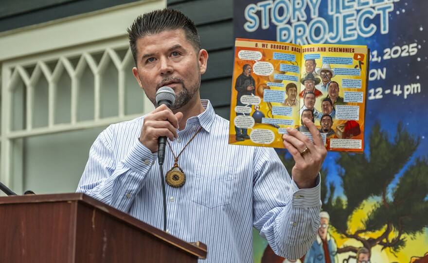 Ethan Banegas reads from a comic book at an event on June 13, 2025 to celebrate the opening of an exhibit at La Jolla Historical Society.