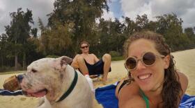 Mary Finley, Travis Sherman and their dog Tonka sit on the beach in this undated photo. 