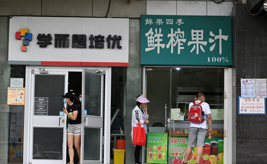 Parents wait in July for their children attending a private after-school class in Beijing's Haidian district.
