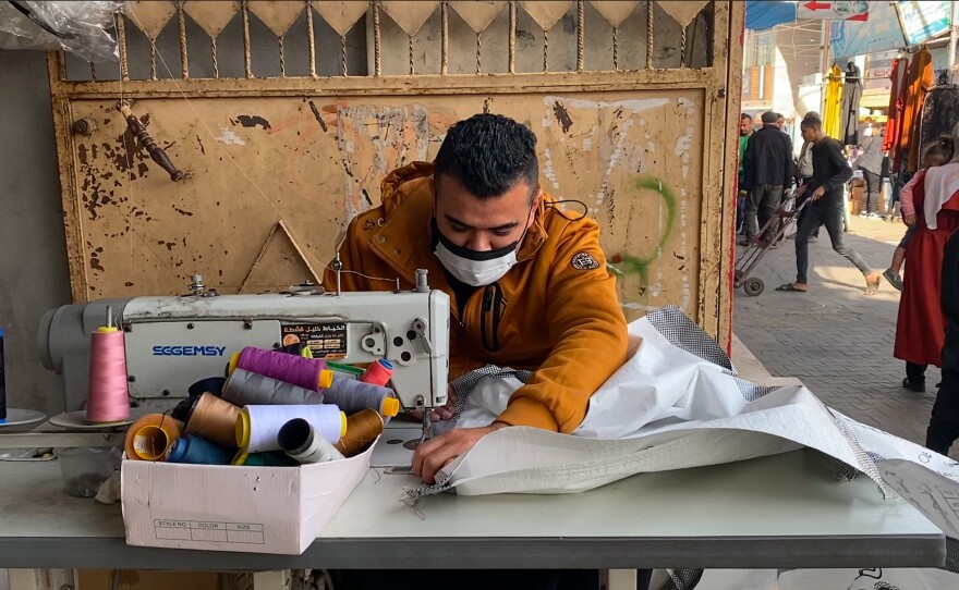 Bags that were used to transfer aid into Gaza are now being repurposed into tent walls.