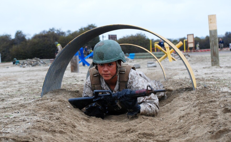 A Marine recruit crawling through a tunnel on the Bayonet Assault Course at Marine Corps Recruit Depot, San Diego, March 23, 2021.