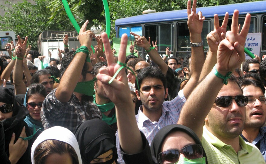 Iranian opposition supporters, wearing green accessories, take part in the Quds (Jerusalem) Day rally in Tehran on September 18, 2009.