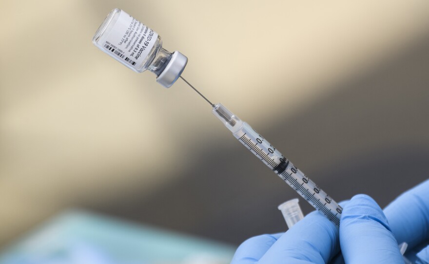 A syringe is filled with a dose of the Pfizer-BioNTech COVID-19 vaccine. While the vaccine has now been authorized for children between ages 5 and 11, it may take several weeks for shots to become widely available.