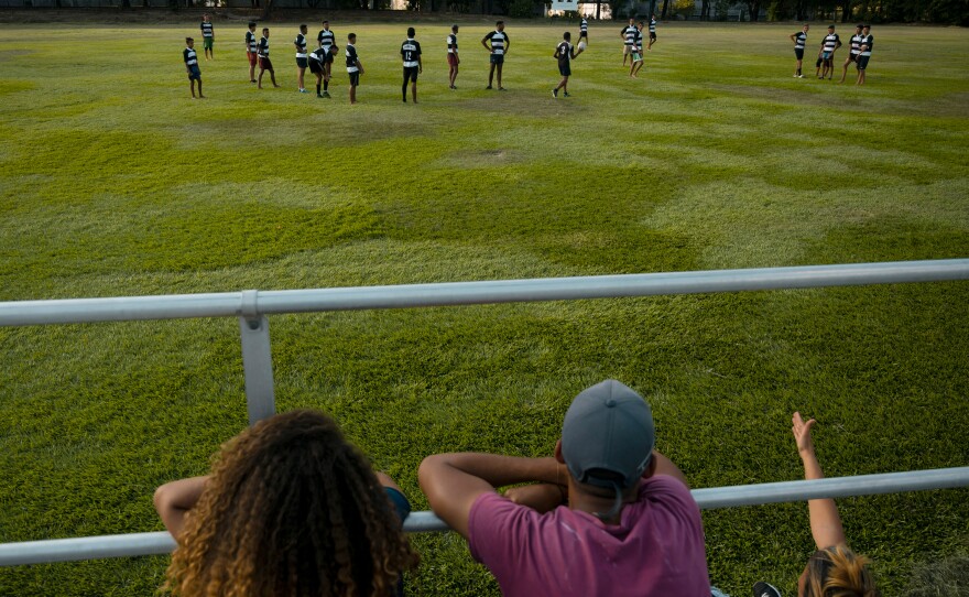 People watch and cheer during rugby practice at Hacienda Santa Teresa.