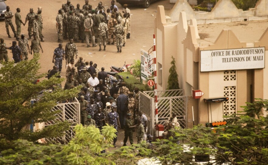Soldiers gather at the offices of the state radio and television broadcaster after announcing a coup in Mali's capital, Bamako, on Thursday. The soldiers said they ousted the president because he wasn't doing enough to halt a rebel insurgency.