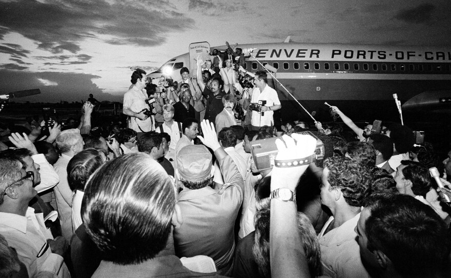 Castro (foreground in hat) signals farewell to Jesse Jackson (top center) at Havana's Jose Marti Airport on June 29, 1984. Castro released 48 political prisoners to Jackson.