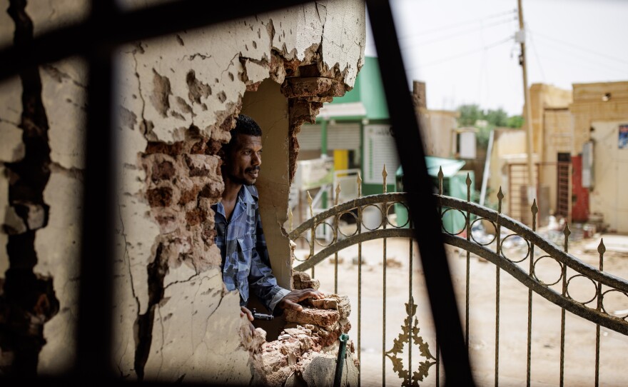 A police officer looks through damage caused by a shell at the Omdurman Maternity Hospital in Omdurman, Sudan, on Sept. 7.