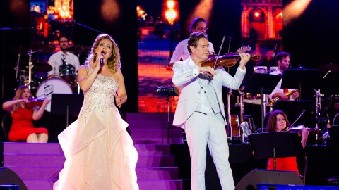 Singer Wendy Kokkelkoren and violin soloist and composer Guido Dieteren perform in "The Maestro and The European Pop Orchestra: Love and Peace Concert"