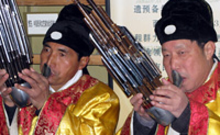 Ensemble members He Zhongxin (left) and Zhao Yuming play the sheng, an ancient Chinese wind instrument.