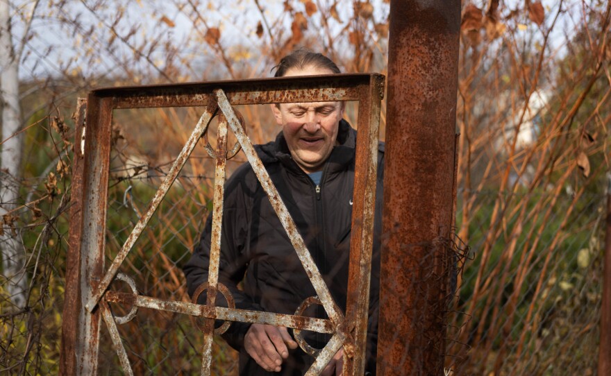 Voinov closes the gate to an electrical substation after looking at the damage.