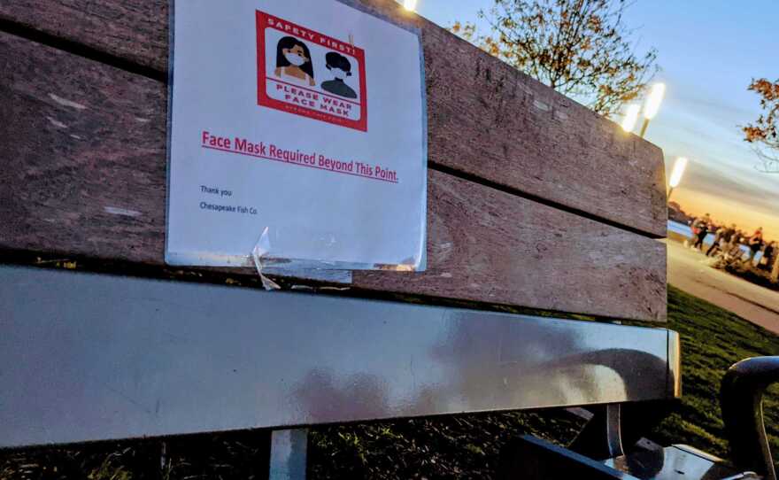 A sign on a bench at Seaport Village advising people to wear a mask, Jan. 2, 2021.