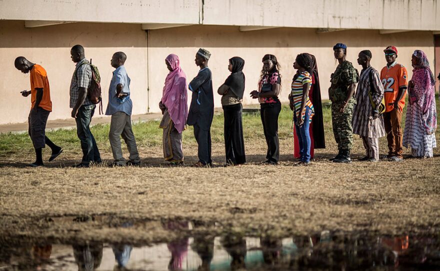 Voters queue at a polling station in Banjul during elections that pose the strongest challenge yet to the current president's 22-year rule.