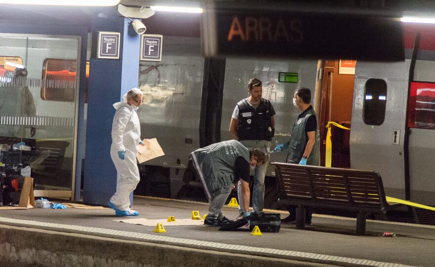 Police shown outside a train north of Paris where three people were wounded in an attack by a Kalashnikov-wielding gunman. The suspect was reportedly subdued by two U.S. Marines, one of whom was seriously wounded.