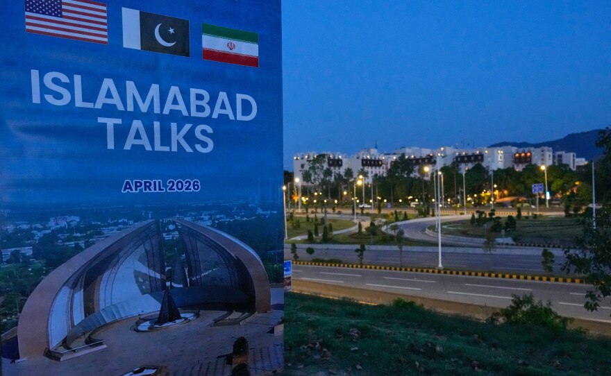 A billboard of the U.S. Iran talks is seen near Serena Hotel, the venue for the U.S. Iran officials meeting, in Islamabad, Pakistan, Sunday, April 12, 2026.