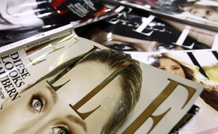 A file picture taken in January 2011 in Paris shows covers of some of the 42 foreign editions of the French fashion magazine "Elle", owned by French media conglomerate Lagardere.