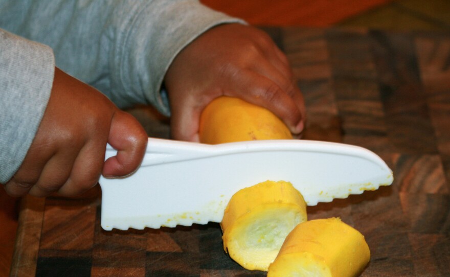 Eka Gupta Goodenough, 3, the author's son, using a starter knife.
