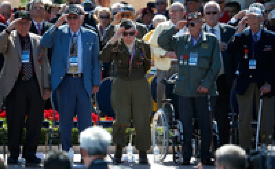 World War II veterans salute as taps is played at a ceremony at the Normandy American Cemetery at Colleville-sur-Mer on Friday, marking the 70th anniversary of D-Day.