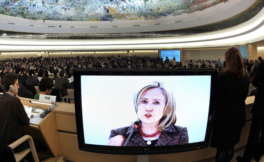 U.S. Secretary of State Hillary Clinton is seen on a TV screen while delivering a speech Monday before the United Nations Human Rights Council in Geneva.