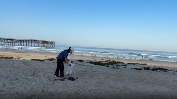 Vi Nguyen picks up trash on Pacific Beach in this undated photo. Nguyen is a local pediatrician who has been picking up plastic along San Diego's coastline for the past seven years.