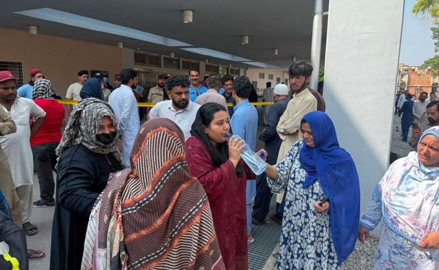 Relatives of the children who died in a hospital fire, gather at the hospital, in Islamabad, Pakistan, Wednesday, Aug. 26, 2026.