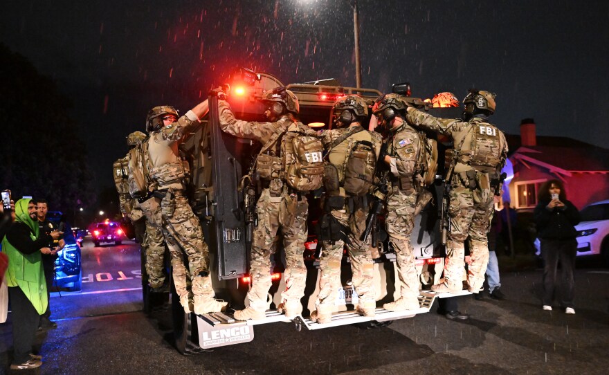FBI officers leave the scene after responding to an address connected to Cole Tomas Allen, the shooting suspect at the White House Correspondents Dinner on Sunday in Torrance, Calif.