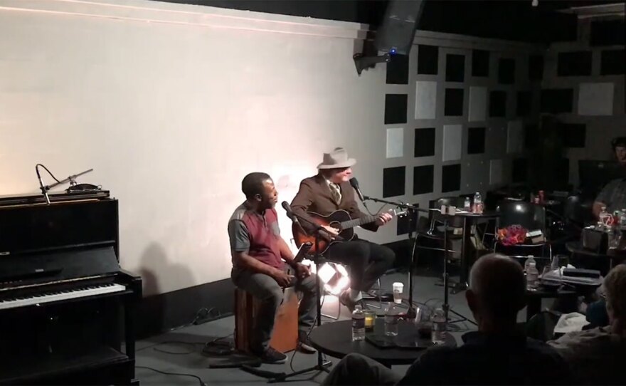 Leonard Patton (left) and Gregory Page (right, with guitar) perform in October 2021 at the Jazz Lounge, shown in a video still.