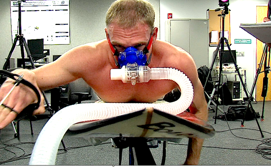 Ross Edmunds simulates paddling in the Cal State San Marcos biomechanics lab. It's part of a study that aims to find out whether recreational surfing is a strenuous exercise.