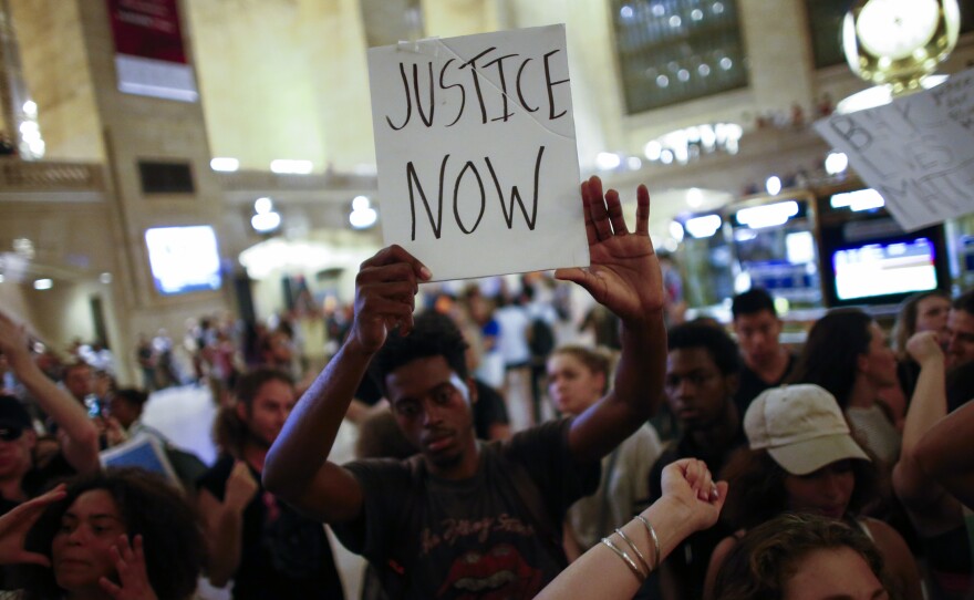 People take part in a protest in New York City's Grand Central Station on Friday.