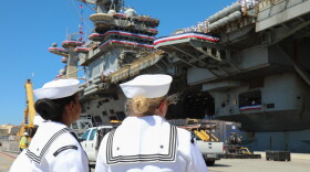 Two Sailors welcome USS Lincoln's landing on Oct. 8, 2026.