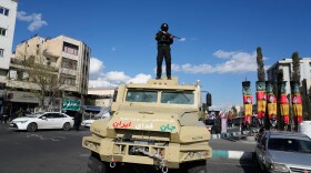 A member of police special forces stands guard on top of a vehicle in downtown Tehran, Iran, Monday.