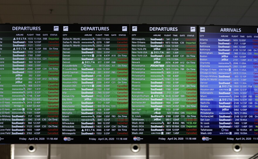 An airline arrival and departure board shows several canceled flights last month at the Tampa International Airport in Tampa, Fla.